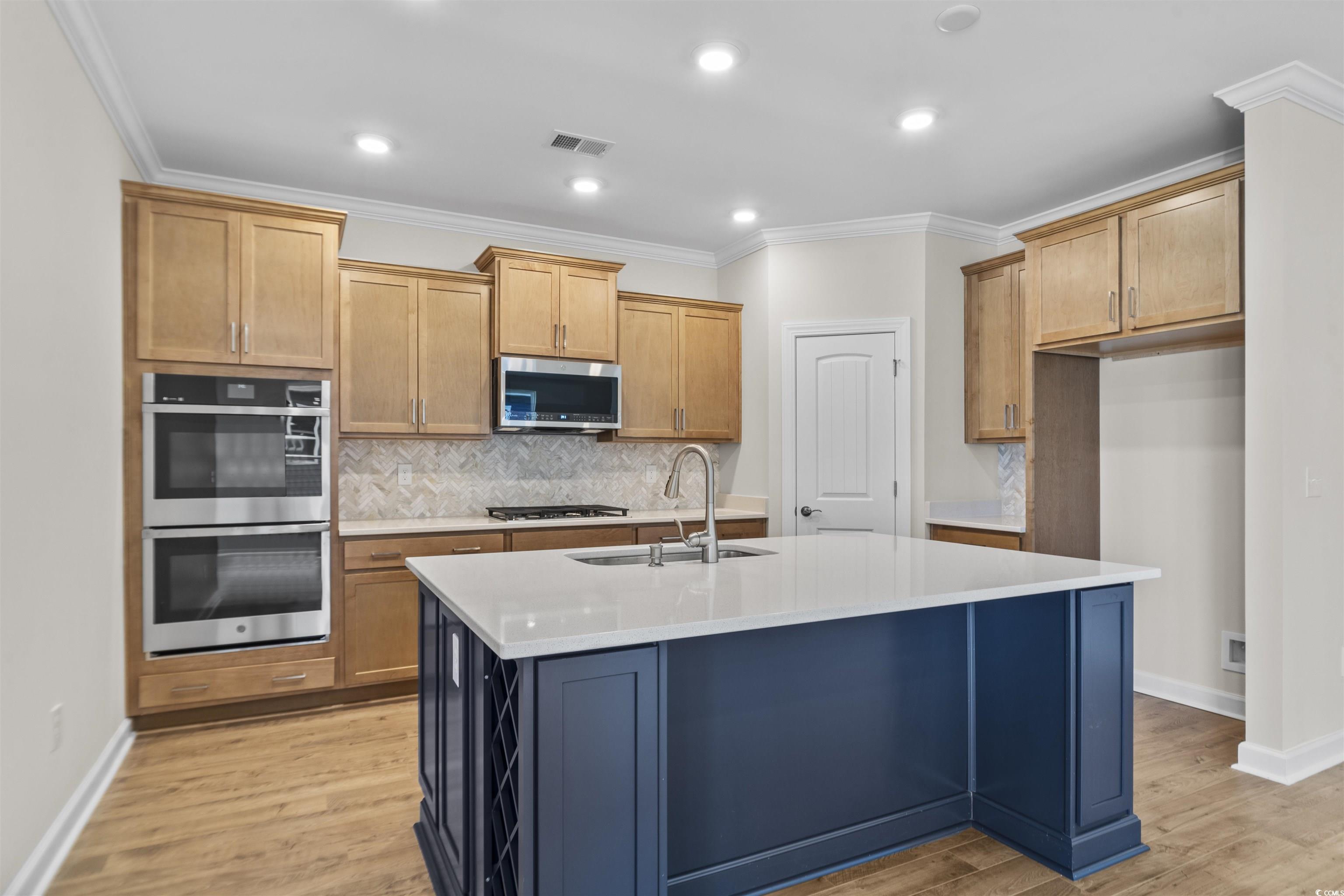 843 Cascade Loop Little River, SC 29566 - Photo 3 of 27 Kitchen featuring a kitchen island with sink, stai