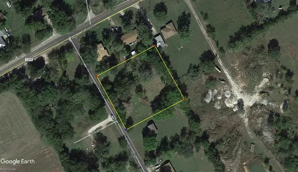 an aerial view of a residential houses with outdoor space