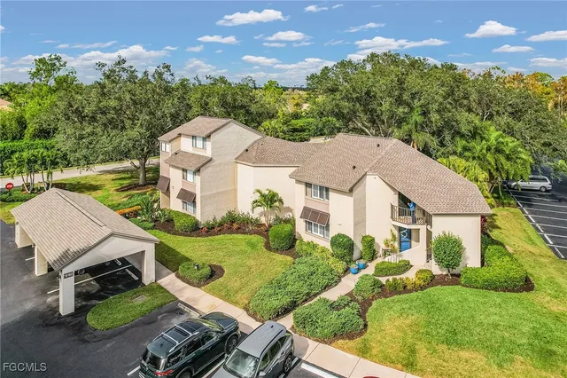 an aerial view of a house with garden space and street view