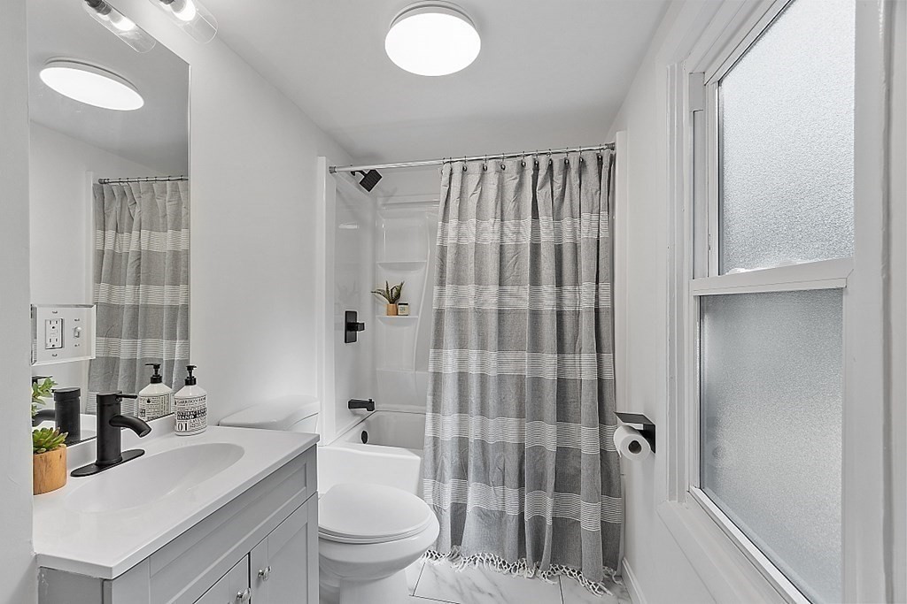 5 Montreal Street Worcester, MA 01604 - Photo 12 of 29 a bathroom with a sink a toilet and shower