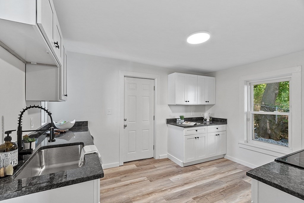5 Montreal Street Worcester, MA 01604 - Photo 15 of 29 a kitchen with granite countertop a stove a sink and a granite counter tops