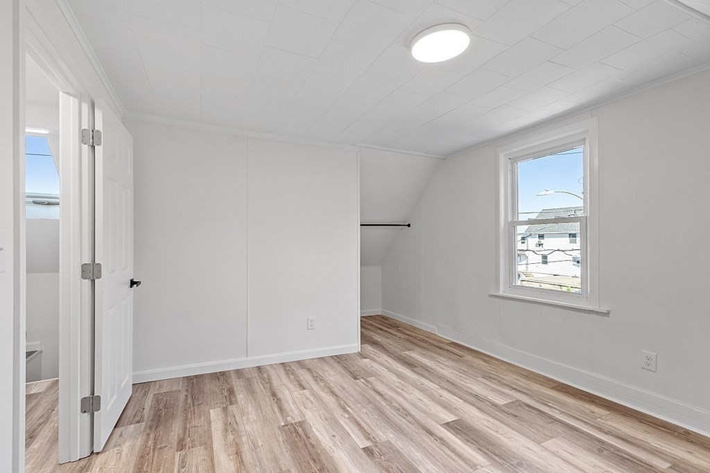 5 Montreal Street Worcester, MA 01604 - Photo 22 of 29 wooden floor in an empty room with a window