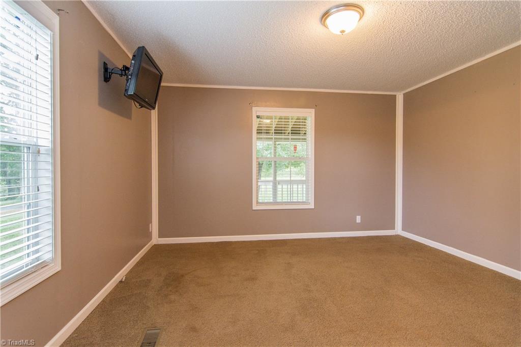 1049 Hickory Fork Road Walnut Cove, NC 27052 - Photo 12 of 24 The master bedroom has a lot of natural light.