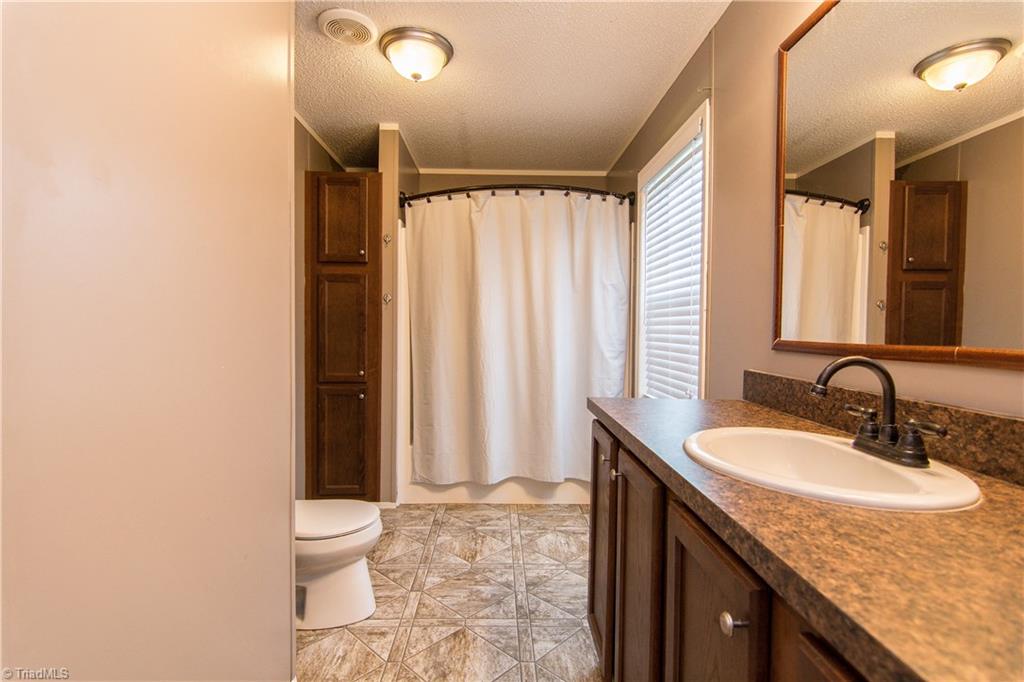1049 Hickory Fork Road Walnut Cove, NC 27052 - Photo 14 of 24 The master bath with linen closet storage.