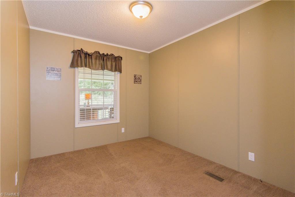 1049 Hickory Fork Road Walnut Cove, NC 27052 - Photo 16 of 24 Bedroom 2 with neutral colors and closet.