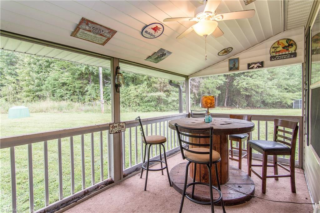 1049 Hickory Fork Road Walnut Cove, NC 27052 - Photo 3 of 24 This screened area of the front porch is a great outdoor eating space, game room and just a place you watch the birds and other wildlife as they are passing through.