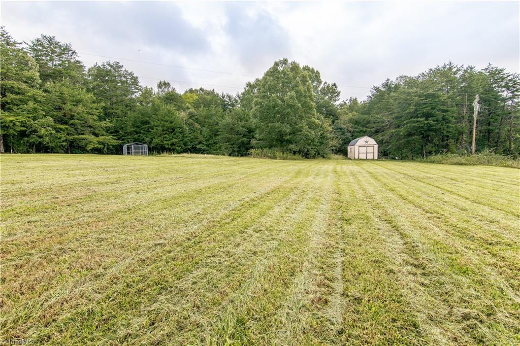 1049 Hickory Fork Road Walnut Cove, NC 27052 - Photo 21 of 24 Enjoy this backyard with custom built storage building and dog run.