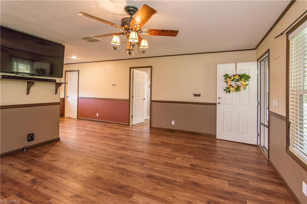 1049 Hickory Fork Road Walnut Cove, NC 27052 - Photo 6 of 24 The great room is large enough for all your furniture needs. It has chair rail throughout the room.