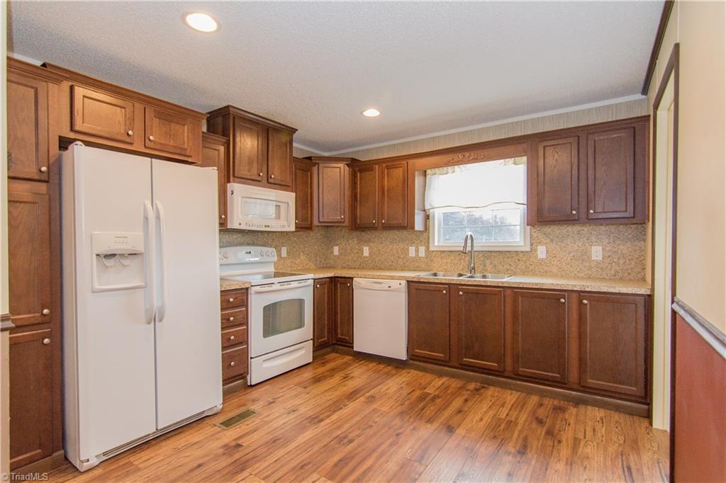 1049 Hickory Fork Road Walnut Cove, NC 27052 - Photo 7 of 24 The eat-in kitchen has plenty of working space and cabinetry storage. The refrigerator will stay.