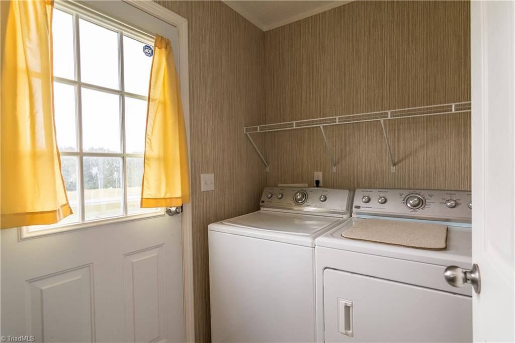 1049 Hickory Fork Road Walnut Cove, NC 27052 - Photo 10 of 24 The laundry room is off the kitchen with access to the backyard. The washer and dryer will stay with the home.