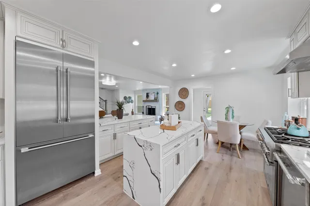 a kitchen with stainless steel appliances a stove sink and cabinets