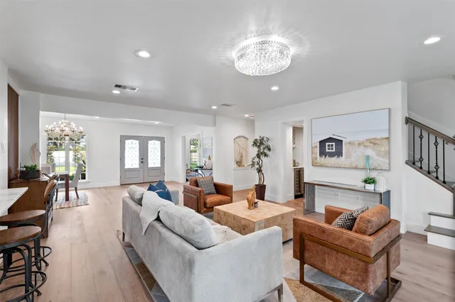 a kitchen with stainless steel appliances kitchen island granite countertop a refrigerator and a stove top oven