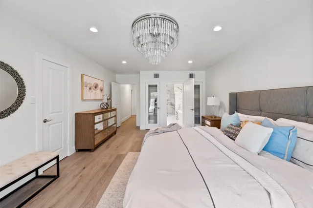 a spacious bedroom with a bed and a table in it