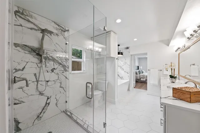a bathroom with a bathtub sink and mirror