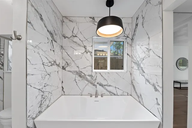 a bathroom with a glass shower door and a sink