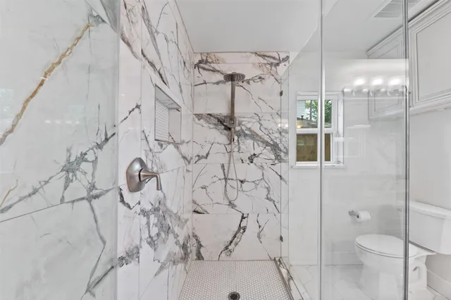 a bathroom with a bathtub and a shower