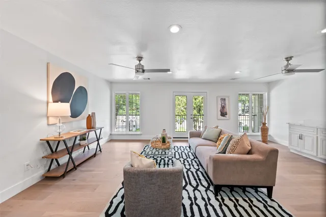 a living room with furniture and wooden floor