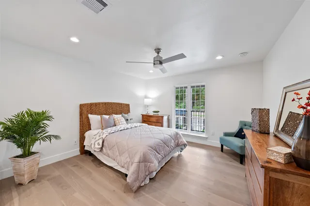 a bathroom with a granite countertop sink a mirror and a bathtub