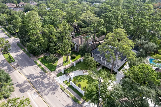 an aerial view of a house with a yard and swimming pool