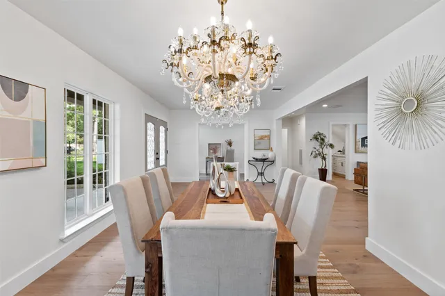 a view of a dining room with furniture and chandelier