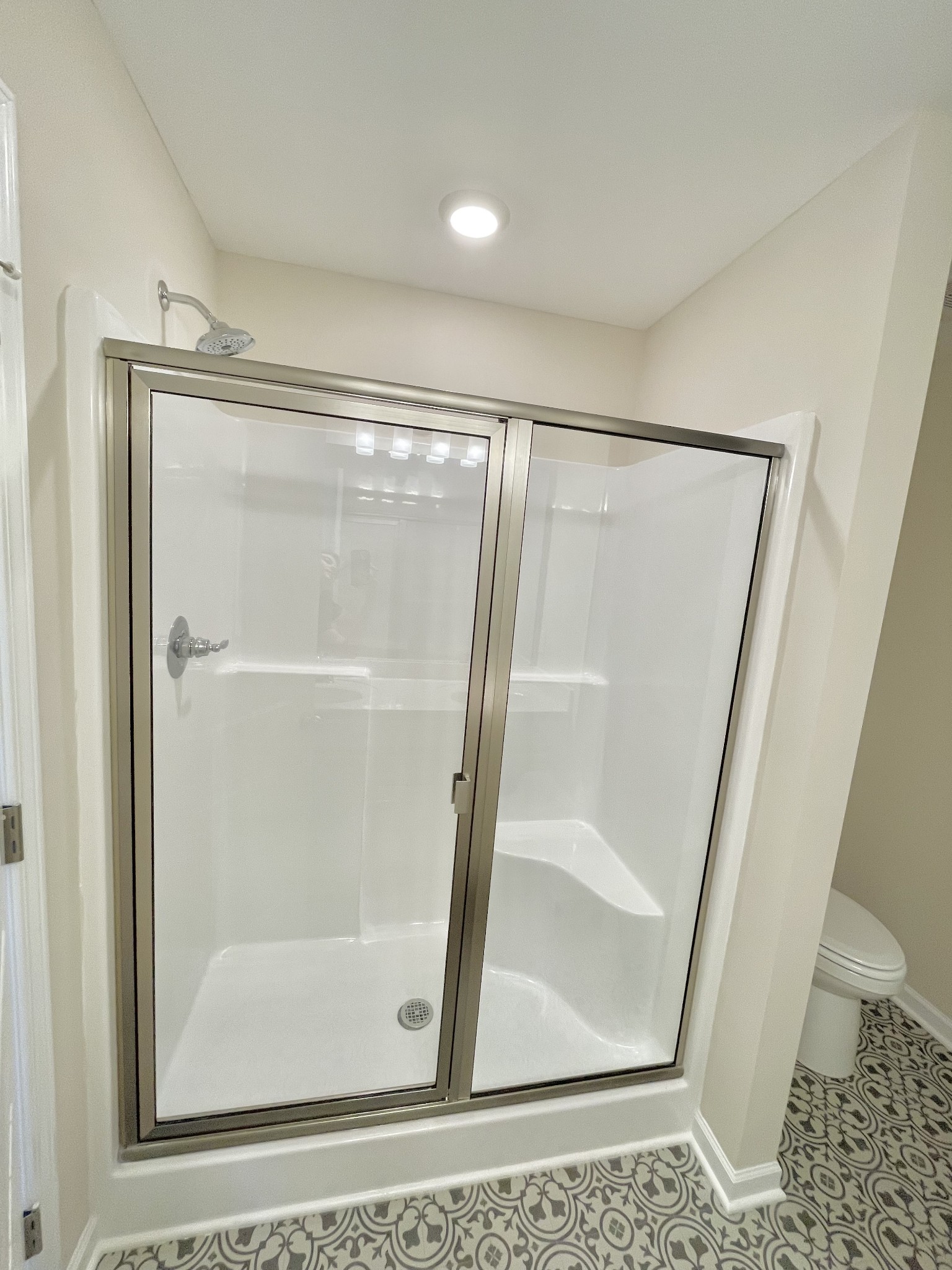 125 Addi Street Pleasant View, TN 37146 - Photo 12 of 14 a bathroom with a glass shower door