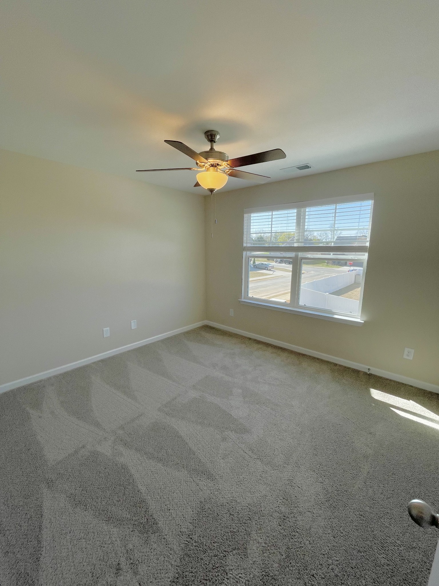 125 Addi Street Pleasant View, TN 37146 - Photo 14 of 14 an empty room with windows and ceiling fan