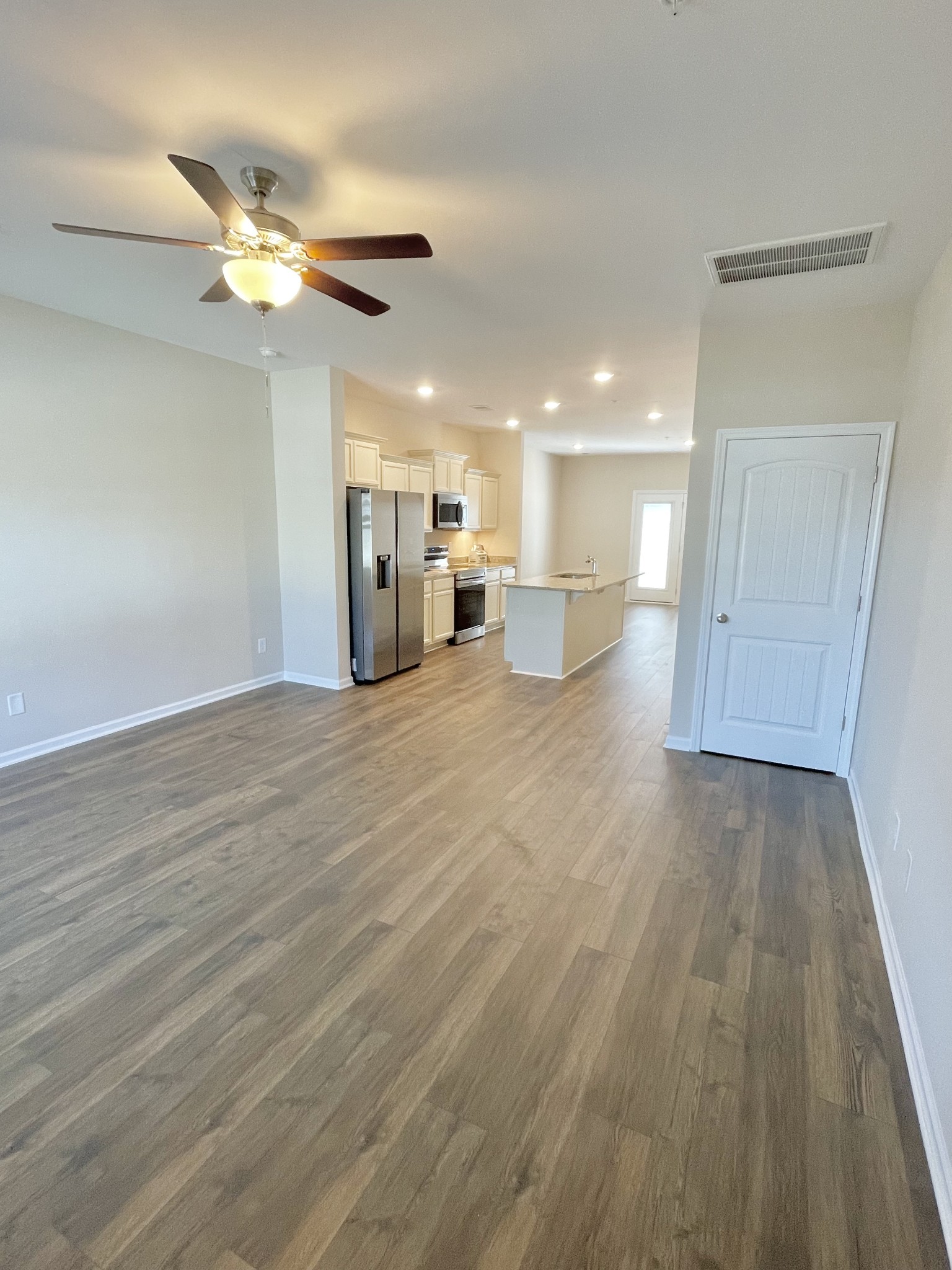 125 Addi Street Pleasant View, TN 37146 - Photo 4 of 14 a view of a livingroom with a ceiling fan and hardwood floor