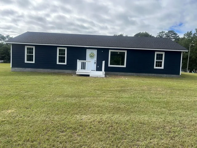 a view of a house with a backyard