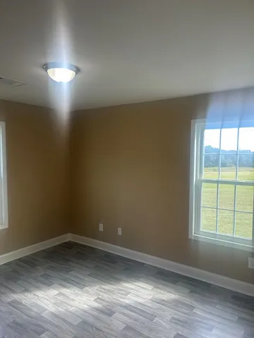 a view of hallway with wooden floor