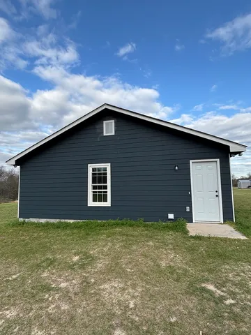 a backyard of a house with lots of green space