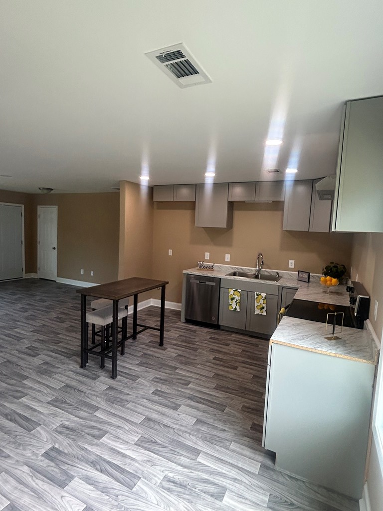 114 Mccarthy Road Buena Vista, GA 31803 - Photo 6 of 27 a kitchen with stainless steel appliances a stove a sink cabinets and wooden floor