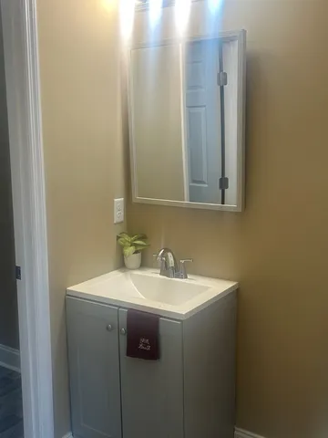 a white toilet sitting in a bathroom next to a sink