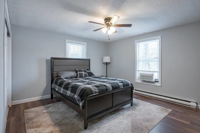 a bed sitting in a bedroom next to a window