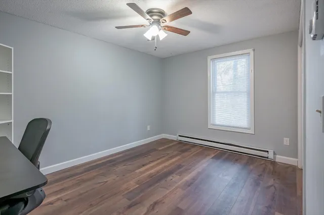 a view of room with window and wooden floor