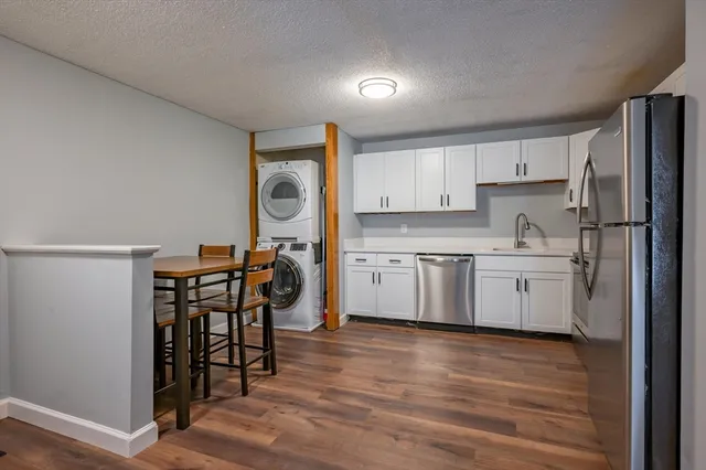 a kitchen with a table chairs sink and cabinets
