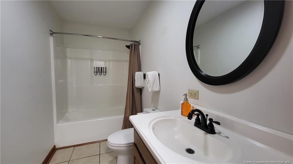 1790 Rozier Church Road Lumberton, NC 28360 - Photo 6 of 12 a bathroom with a sink a toilet and a mirror