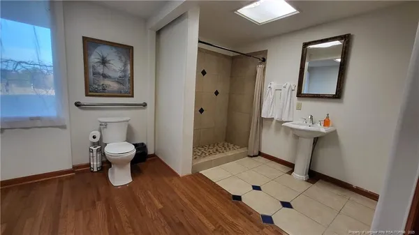 a bathroom with a toilet and a mirror
