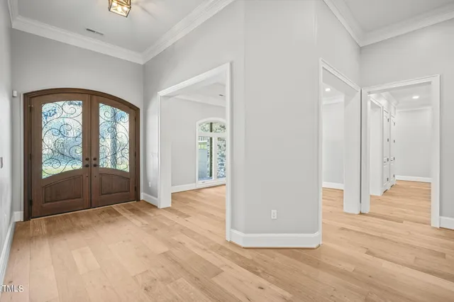 a view of a room with wooden floor and a fireplace
