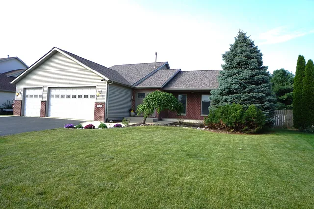 a front view of a house with a yard and garage