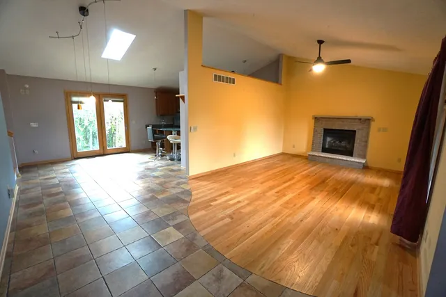 a view of a livingroom with a fireplace and window