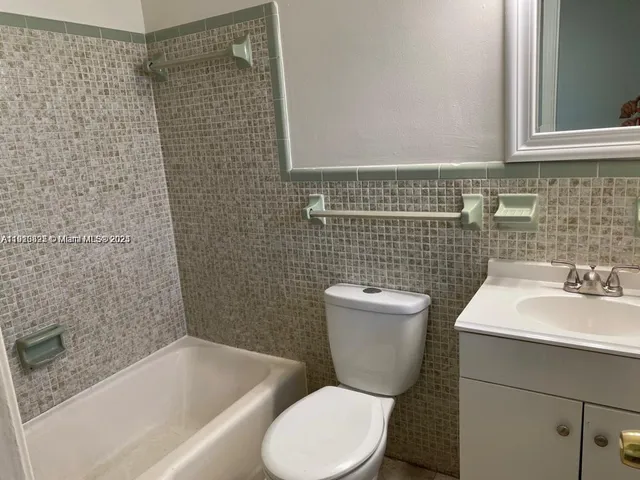 a bathroom with a toilet a sink and bathtub