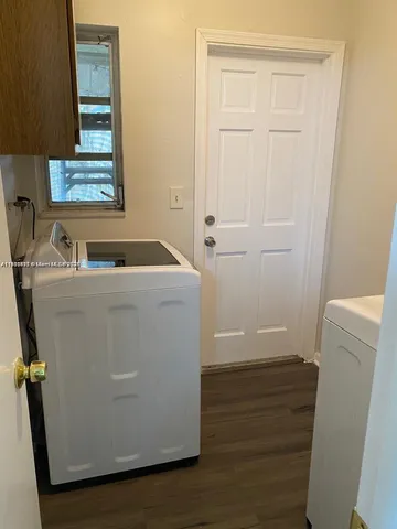 a room with sink dryer and washer