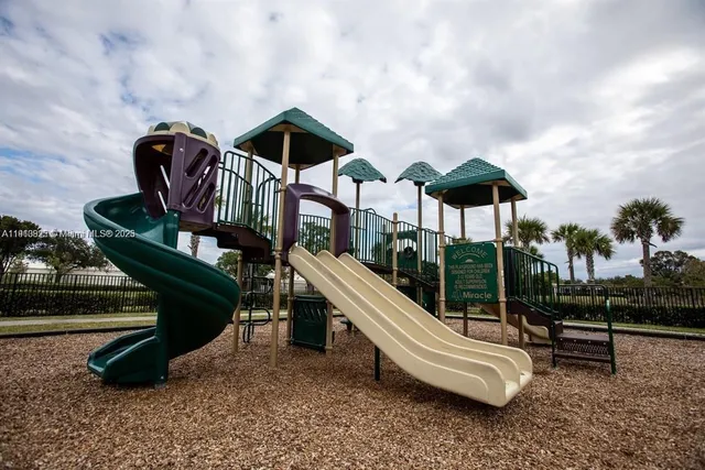 an outdoor sitting area with chairs and wooden fence