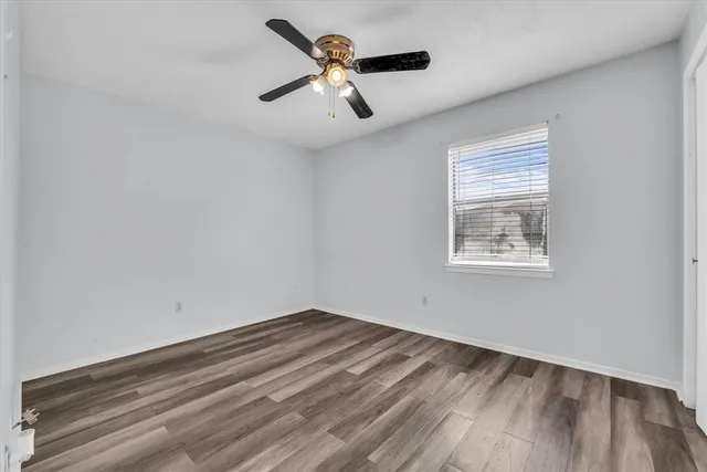a bathroom with a toilet sink vanity and mirror