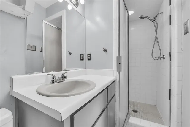 a bathroom with a sink toilet and shower