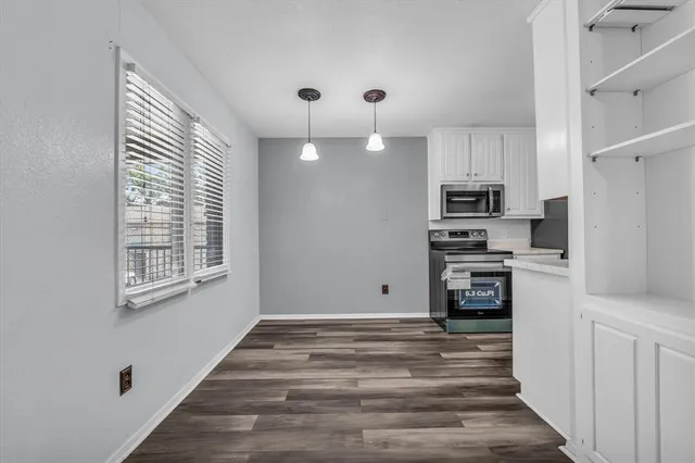 a kitchen with a sink cabinets and appliances
