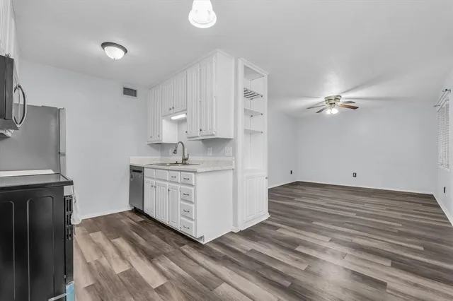 a kitchen with stainless steel appliances granite countertop a stove a sink dishwasher and a refrigerator