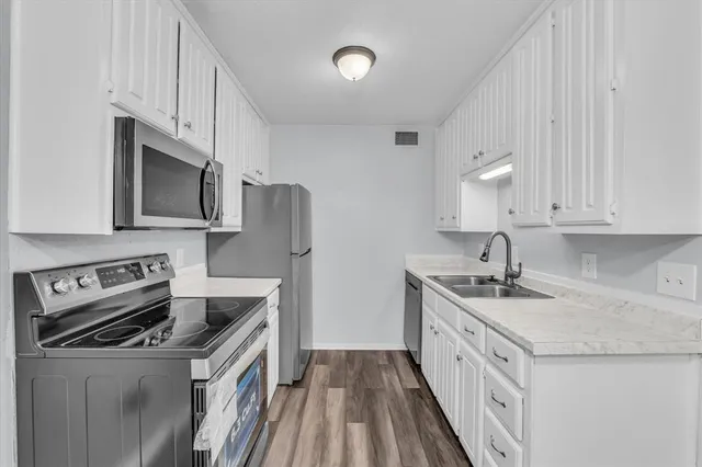 a kitchen with a sink and cabinets