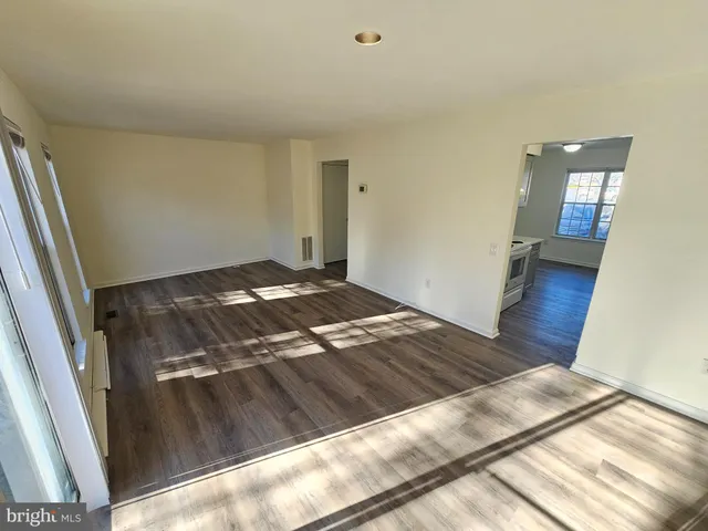 a view of an empty room and wooden floor
