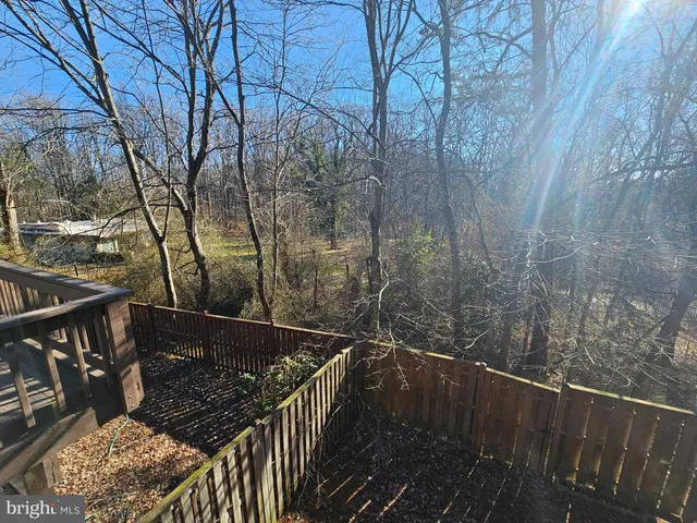 a view of balcony with wooden floor and fence